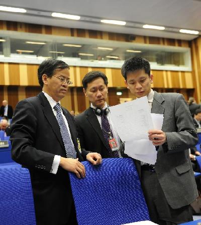 Cheng Jingye (1st L), China's permanent representative and ambassador to the United Nations and other international organizations in Vienna, prepares for a meeting of the International Atomic Energy Agency (IAEA) in Vienna, Austria, on March 8, 2012. [Xu Liang/Xinhua] 