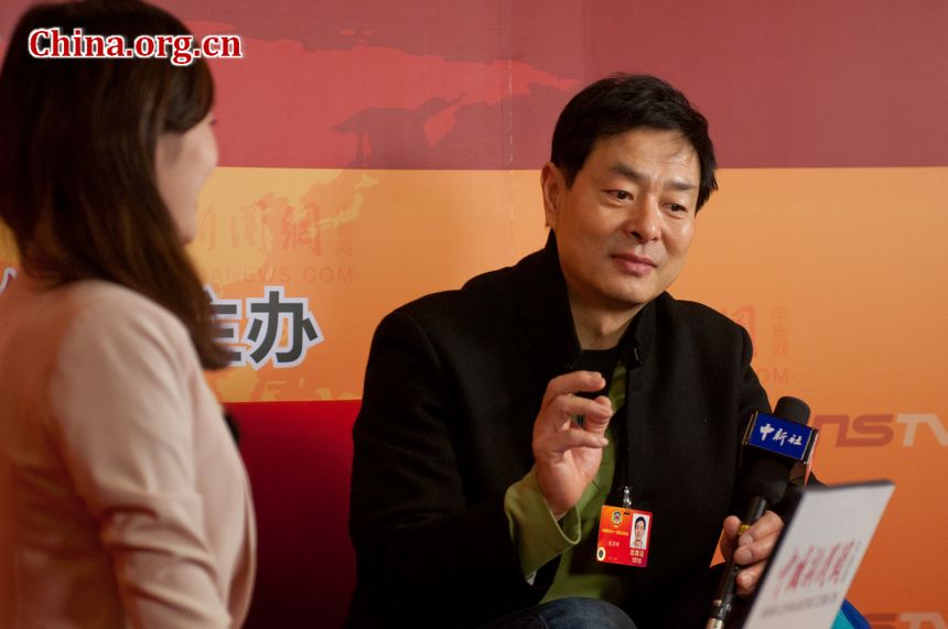 Pu Cunxin (R), member of the Chinese People's Political Consultative Conference (CPPCC), is also a well known actor and an HIV/AIDS activist in China. He is interviewed by China News Service shortly before the second plenary of this year's CPPCC session starts on Friday, March 9, 2012, at the Great Hall of the People, in Beijing, China. [China.org.cn]