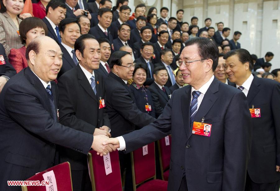 He Guoqiang (R, front), member of the Standing Committee of the Political Bureau of the Communist Party of China (CPC) Central Committee and secretary of the CPC Central Commission for Discipline Inspection, visits deputies to the Fifth Session of the 11th National People's Congress (NPC) from central China's Henan Province and joins their panel discussion in Beijing, capital of China, March 9, 2012. (Xinhua/Huang Jingwen) 