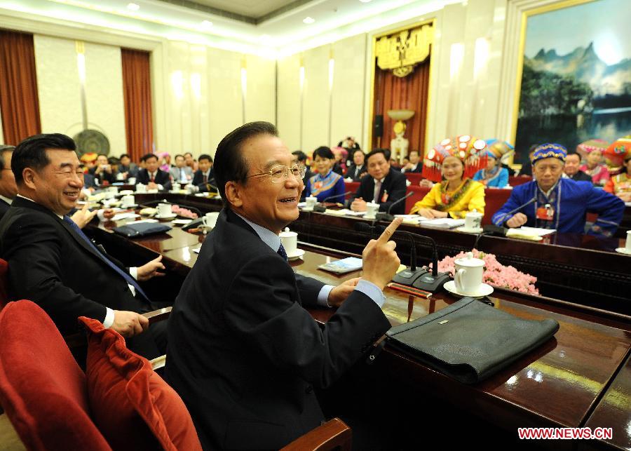 Chinese Premier Wen Jiabao (R, front), who is also a member of the Standing Committee of the Political Bureau of the Communist Party of China (CPC) Central Committee, visits deputies to the Fifth Session of the 11th National People's Congress (NPC) from south China's Guangxi Zhuang Autonomous Region and joins their panel discussion in Beijing, capital of China, March 9, 2012. (Xinhua/Liu Jiansheng) 