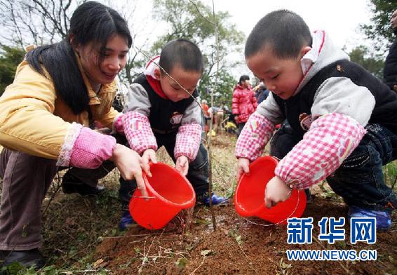 People plant trees on the 34th national Tree Planting Day in Guilin, Guangxi Zhuang Autonomous Region, March 12, 2012. 