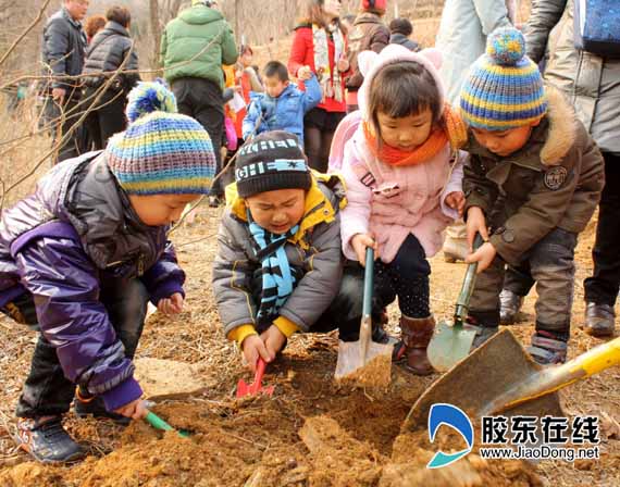 Children plant trees on the 34th national Tree Planting Day in Yantai, Shandong Province, March 12, 2012.