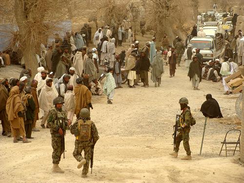 Afghan National Army soldiers keep watch as Afghans gather around the killing site in Kandahar province, March 11, 2012. [Photo/Agencies] 