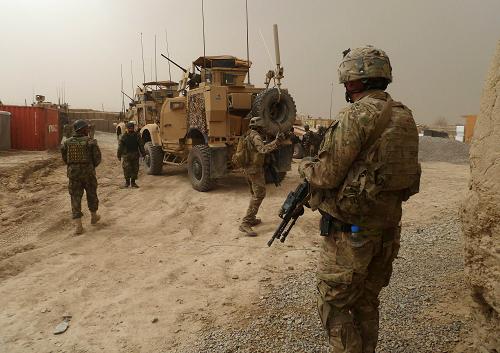 US soldiers keep watch at the entrance of a military base near Alkozai village following the shooting of Afghan civilians allegedly committed by a rogue US soldier in Panjwayi district, Kandahar province on March 11, 2012. [Xinhua] 