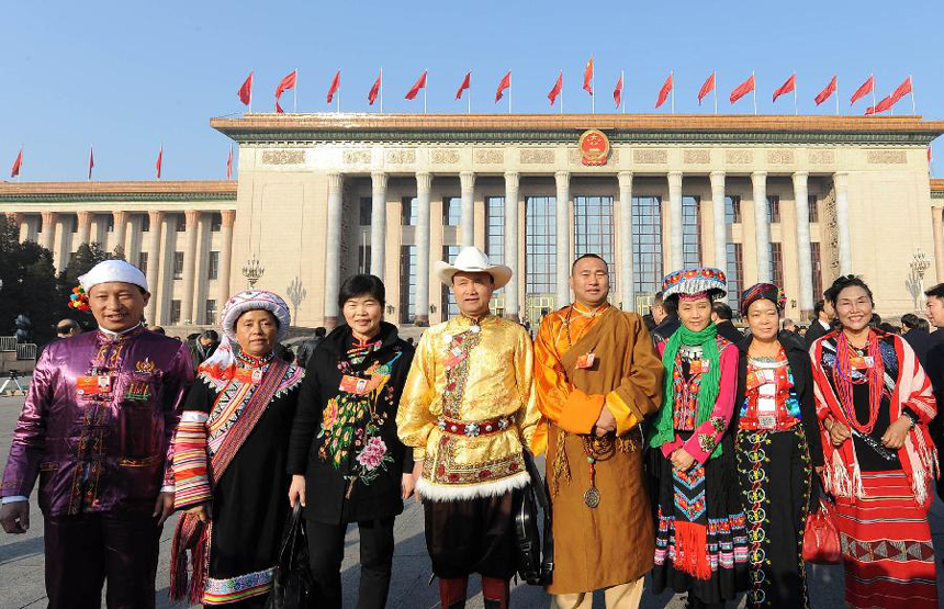 Members of the 11th National Committee of the Chinese People's Political Consultative Conference (CPPCC) pose for photos outside the Great Hall of the People prior to the closing meeting of the Fifth Session of the 11th CPPCC National Committee in Beijing, capital of China, March 13, 2012.