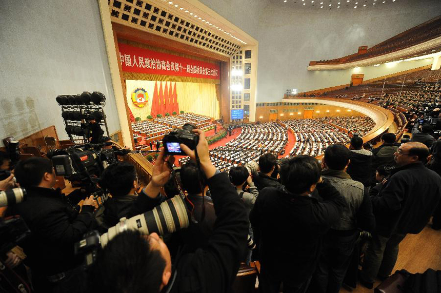 Journalists work during the closing meeting of the Fifth Session of the 11th National Committee of the Chinese People's Political Consultative Conference (CPPCC) at the Great Hall of the People in Beijing, capital of China, March 13, 2012. 