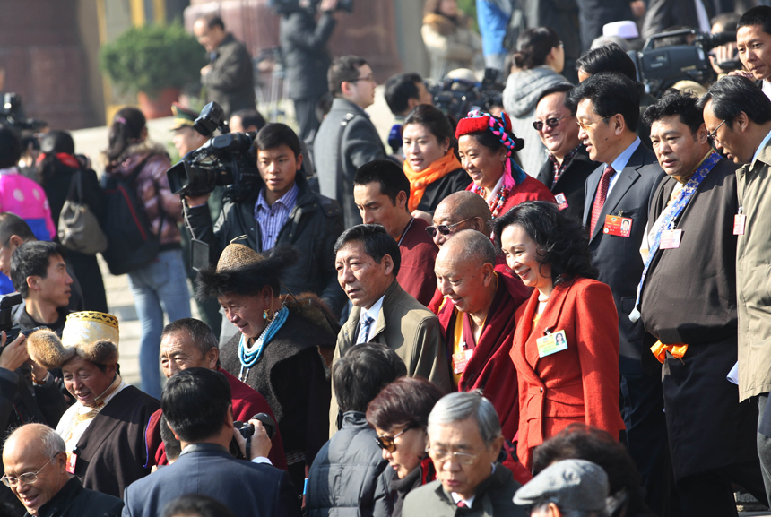 Members of the 11th National Committee of the Chinese People's Political Consultative Conference (CPPCC) walk out of the Great Hall of the People after the closing meeting of the Fifth Session of the 11th CPPCC National Committee in Beijing, March 13, 2012. 