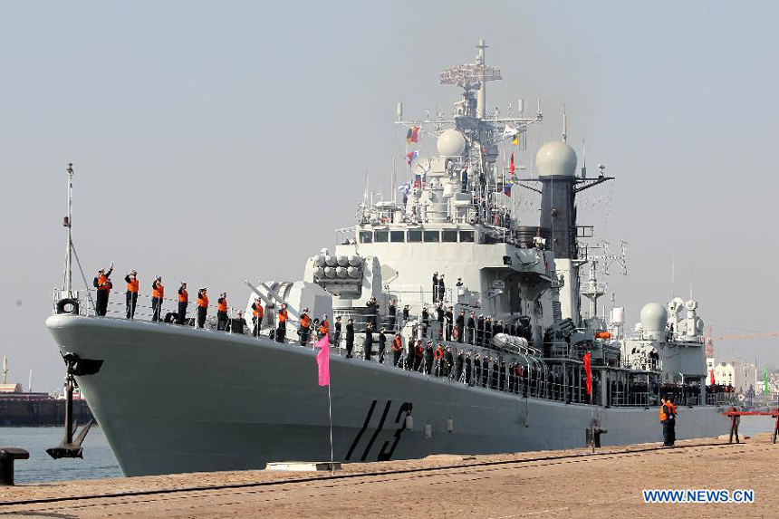 Soldiers of the destroyer 'Qingdao' (L) bid farewell to relatives and friends at a port in Qingdao, east China's Shandong Province, Feb. 27, 2012. The 11th Chinese naval escort flotilla, consisting of destroyer 'Qingdao', frigate 'Yantai' and comprehensive supply ship 'Huishanhu', departed from Qingdao on Monday for the escort mission in the Gulf of Aden and Somali waters to protect commercial ships from pirate attacks. 