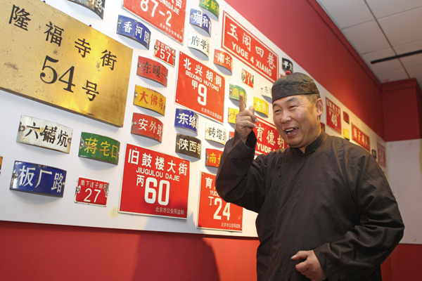 Song Zhenzhong shows off his collection of old signs of Beijing's streets, roads and hutong. Photos by Feng Yongbin / China Daily