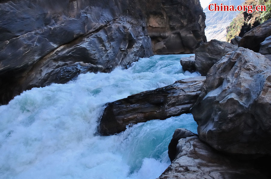 Hutiao Gorge is located on the upper reaches of the Jinsha River, to the northeast of Lijiang, in southwest China's Yunnan Province. The narrowest stretch in the river is only about 30 meters across and carries the legend that a tiger could easily jump across the river. The river is about 29 km long, reaching 3,790 meters in depth between Jade Dragon and Haba Snow Mountains, creating one of the most spectacularly deep gorges in the world. [China.org.cn]