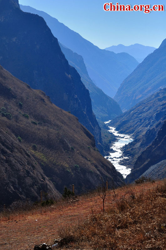 Hutiao Gorge is located on the upper reaches of the Jinsha River, to the northeast of Lijiang, in southwest China's Yunnan Province. The narrowest stretch in the river is only about 30 meters across and carries the legend that a tiger could easily jump across the river. The river is about 29 km long, reaching 3,790 meters in depth between Jade Dragon and Haba Snow Mountains, creating one of the most spectacularly deep gorges in the world. [China.org.cn]