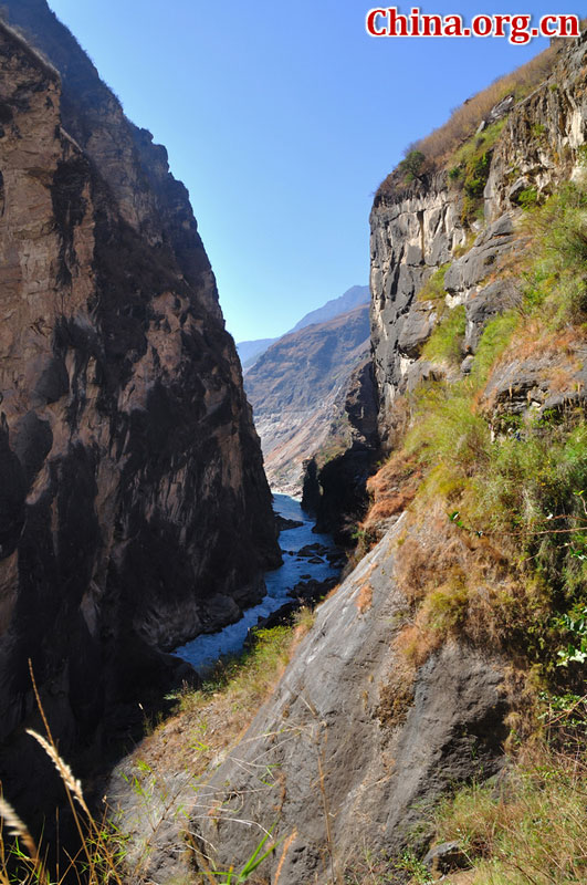 Hutiao Gorge is located on the upper reaches of the Jinsha River, to the northeast of Lijiang, in southwest China's Yunnan Province. The narrowest stretch in the river is only about 30 meters across and carries the legend that a tiger could easily jump across the river. The river is about 29 km long, reaching 3,790 meters in depth between Jade Dragon and Haba Snow Mountains, creating one of the most spectacularly deep gorges in the world. [China.org.cn]