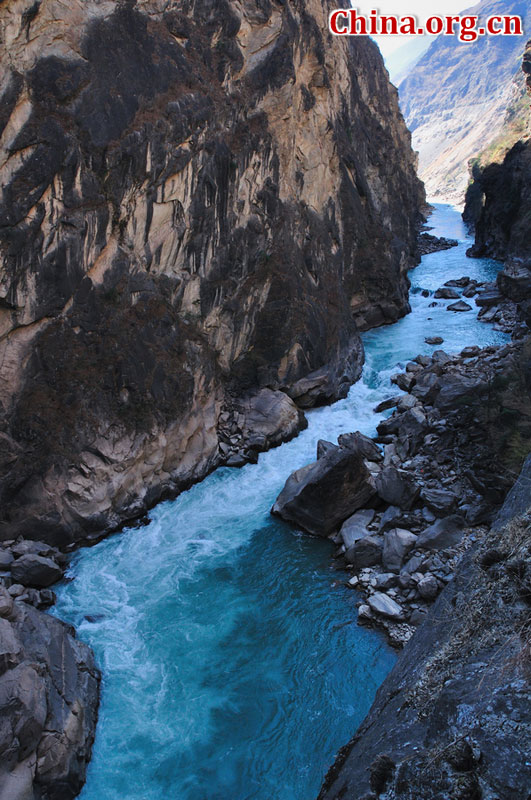 Hutiao Gorge is located on the upper reaches of the Jinsha River, to the northeast of Lijiang, in southwest China's Yunnan Province. The narrowest stretch in the river is only about 30 meters across and carries the legend that a tiger could easily jump across the river. The river is about 29 km long, reaching 3,790 meters in depth between Jade Dragon and Haba Snow Mountains, creating one of the most spectacularly deep gorges in the world. [China.org.cn]