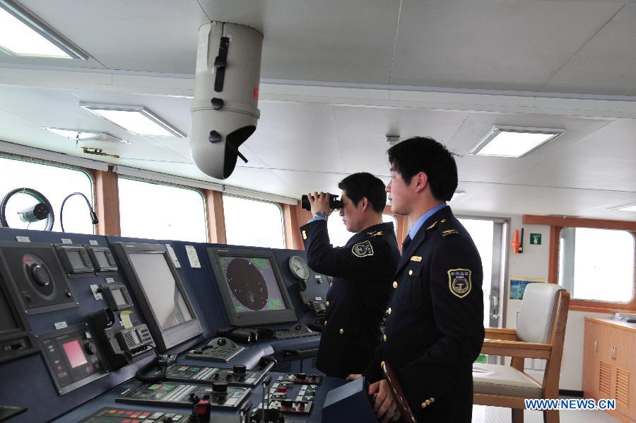 Chief officer Li Yimin (L) and sailor Zhu Yaotao control China's patrol ship 'Haijian 50' to patrol in waters near the Diaoyu Islands, March 16, 2012. The patrol by China Marine Surveillance, the country's maritime law enforcement authorities, was carried out by two patrol ships 'Haijian 50' and 'Haijian 66', which arrived in waters near the Diaoyu Island and its affiliated isles in the early morning of Friday. Authorized by the Chinese State Council, the State Oceanic Administration (SOA), the country's maritime authority, and the Ministry of Civil Affairs released standard names of the Diaoyu Island and its affiliated isles recently. 