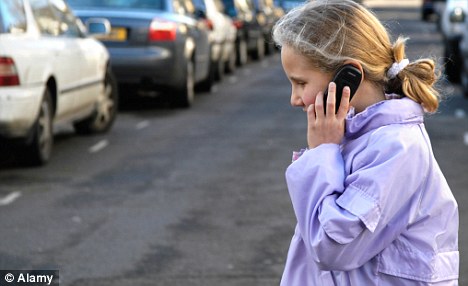 Workers on their way to the office often ignore the road in favour of talking on the mobile phones. [Agencies]