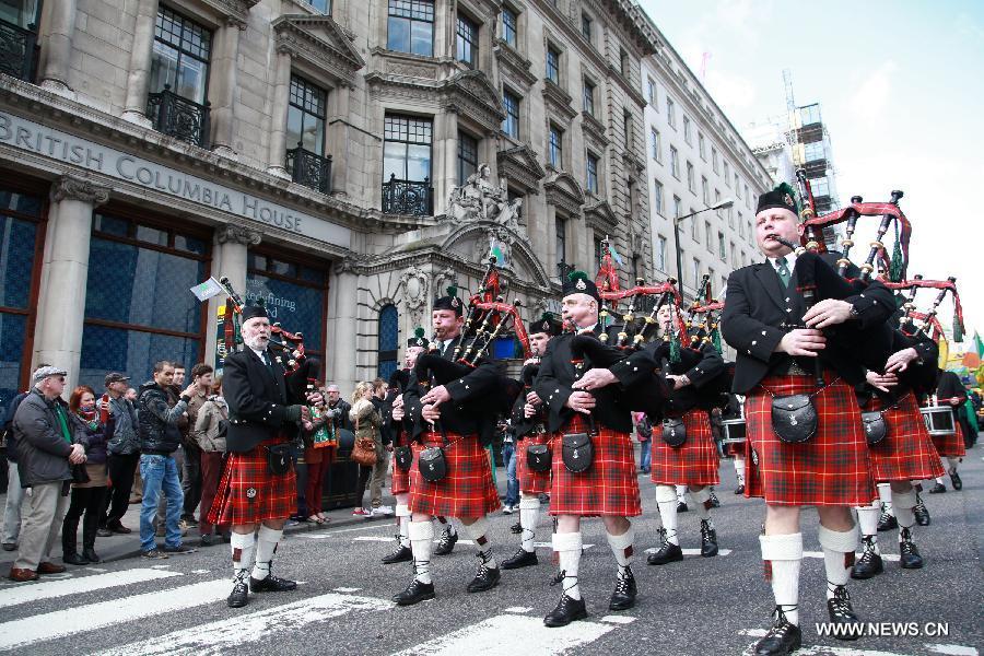 A bagpipe band marches during the St. Patrick's Day parade in central London, Britain, March 18, 2012. St. Patrick's Day is a religious holiday celebrated internationally on March 17. It is named after Saint Patrick, the most commonly recognized of the patron saints of Ireland. (Xinhua/Xiang Mei) 