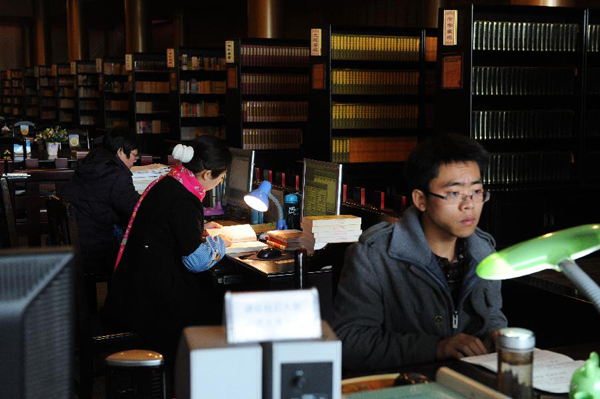 Several layman Buddhists work in the library of the Buddhist Academy of Emei Mountain in Emei Mountain, southwest China's Sichuan province, March 16, 2012. Established in 1927, the school, covering an area of more than 10,000 square meters presently, has courses mainly on Buddhism studying. [Photo/Xinhua] 