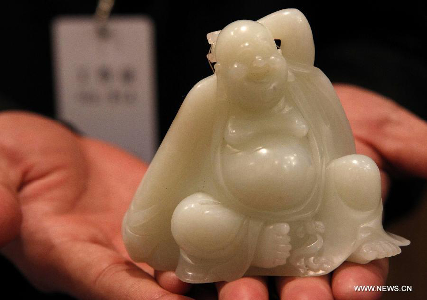 Photo taken on March 21, 2012 shows a jade buddha figurine displayed during the preview of the 29th China Guardian Quarterly Auction in Beijing. The three-day quarterly auction will kick off here on March 24, following a three-day preview that started on Wednesday. The preview exhibits some 2,600 Chinese painting and calligraphy works, 1,800 pieces of chinaware, furniture and craftwork, as well as 680 rare books and manuscripts.