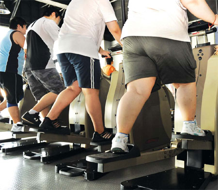 Young men exercising on treadmills at an Impulse Total Fitness club in Weifang, Shandong province. In China, slimmer employees are favored in many industries while overweight workers might be labeled as lazy and not trustworthy. In the past it was mainly women who were obsessed with losing weight and shaping their figures but recently more men have also got in on the act. [China Daily]