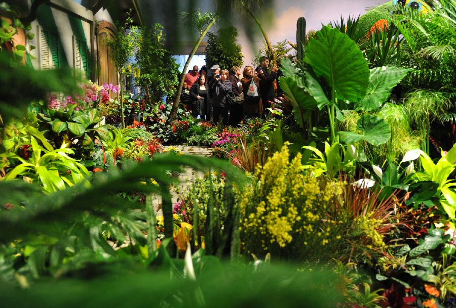 People visit at the Macy's Flower Show in New York, the United States, March 26, 2012. The 38th annual Macy's Flower Show enlisted six of the world's most brilliant and renowned floral designers to create a spectacular exhibition of flowers. (Xinhua/Wang Lei) 