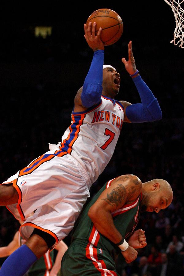 Carmelo Anthony of the New York Knicks drives for a shot attempt in the second half against Drew Gooden of the Milwaukee Bucks at Madison Square Garden on March 26, 2012 in New York City. Knicks beats Milwaukee Bucks 89-80. (Xinhua / AFP Photo)
