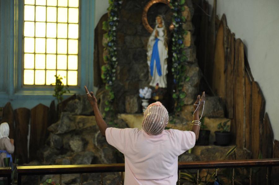 Photo taken on March 27, 2012 shows a woman praying in the Cathedral of the Immaculate Conception in Port-of-Spain, capital of Trinidad and Tobago. The Cathedral, built in 1831, is one of the oldest churches in the Caribbean region. (Xinhua/Weng Xinyang) 