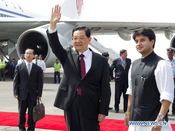 Chinese President Hu Jintao waves as he arrives in New Delhi, capital of India, March 28, 2012. Hu Jintao arrived here for a summit of Brazil, Russia, India, China and South Africa, the grouping known as BRICS. 