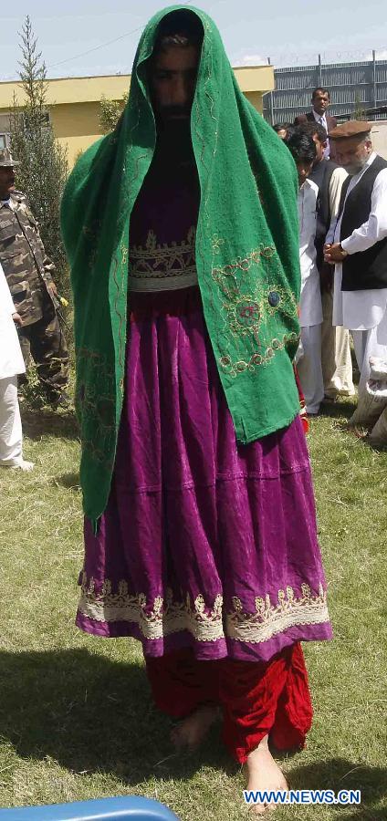 A Taliban fighter who wearing the traditional women clothes is showed for the media after being captured by the Afghan national security forces in Laghman Province, east of Kabul, capital of Afghanistan on March 28, 2012. Seven male Taliban fighters wearing female clothes captured by Afghan security forces during their operations in Laghman Province, official said. 