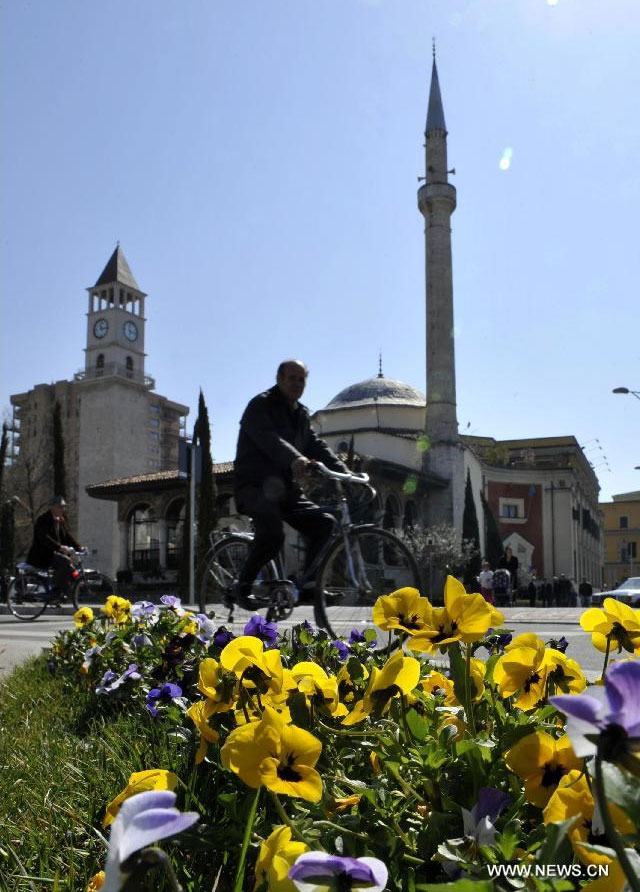 Flowers are seen in front of the Et'hem Bey Mosque and the Clock Tower in Tirana, Albania, March 18, 2012. Varieties of spring flowers flourish as the northern hemisphere have entered its springtime since March. (Xinhua/Wu Wei) 