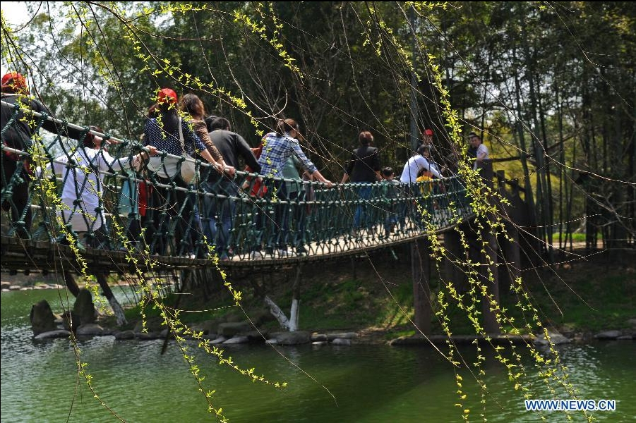 Visitors tour a bamboo park in Anji County, east China's Zhejiang Province, March 27, 2012. (Xinhua/Tan Jin) 