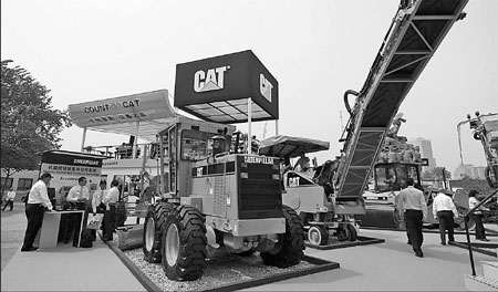 Caterpillar's engineering machinery products on display at an exhibition in Beijing. The company plans to double the number of its employees in China by 2015. [China Daily]