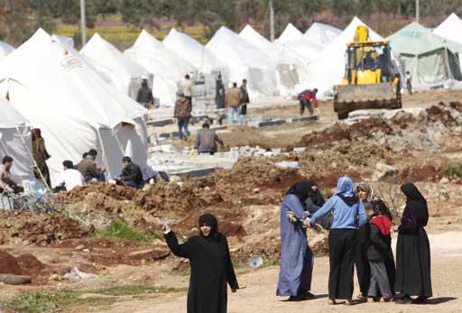 Syrian refugee women chat at Reyhanli refugee camp in Hatay province on the Turkish- Syrian border March 17, 2012.