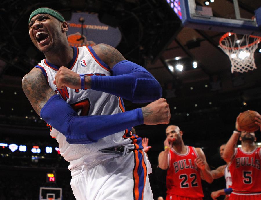 New York Knicks forward Carmelo Anthony reacts after making a shot and being fouled by the Chicago Bulls in the fourth quarter of their NBA basketball game at Madison Square Garden in New York, April 8, 2012. (Xinhua/ Reuters Photo) 