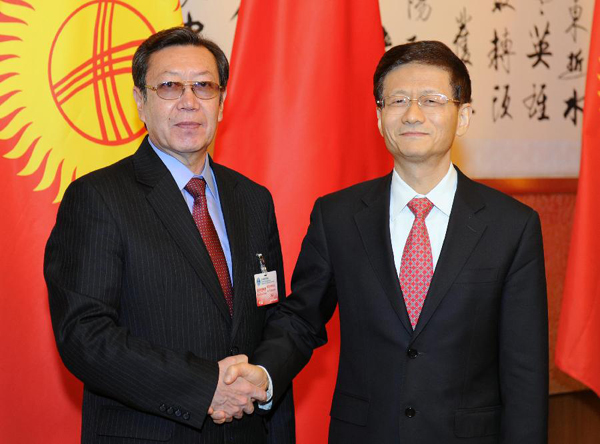 Chinese State Councilor Meng Jianzhu (R) shakes hands with Kyrgyz Secretary of Defense Council Busurmankul Tabaldiyev in Beijing, capital of China, April 11, 2012. Busurmankul Tabaldiyev came to Beijing to attend the seventh session of the Shanghai Cooperation Organization (SCO) security council secretaries. [Xie Huanchi/Xinhua] 