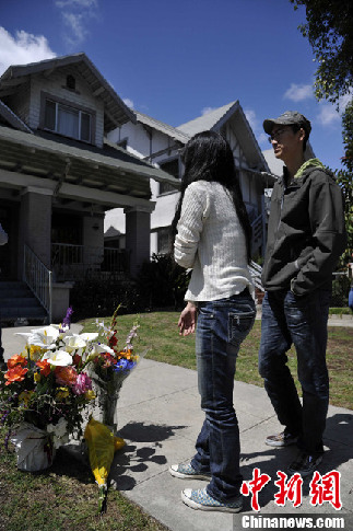 People leave flowers at the scene where two international students from China were shot dead on Wednesday in a 'gang-infested' area near the University of Southern California in Los Angeles, California, April 11, 2012.