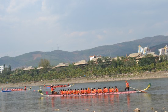 Dragon boats move upstream to prepare for their race, Jinghong City, Yunnan Province, Apr. 13.