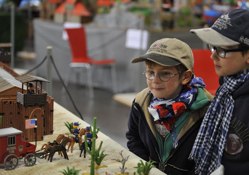 Children are attracted by toys during a toy exhibition and fair of a Germany toy brand staged in Seneffe of Belgium, April 15, 2012