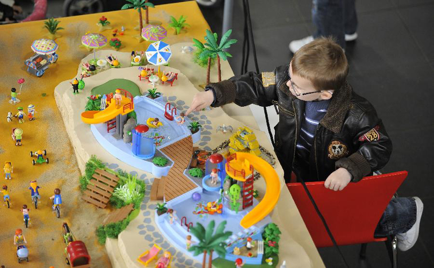 A boy is attracted by toys during a toy exhibition and fair of a Germany toy brand staged in Seneffe of Belgium, April 15, 2012. [Xinhua photo]