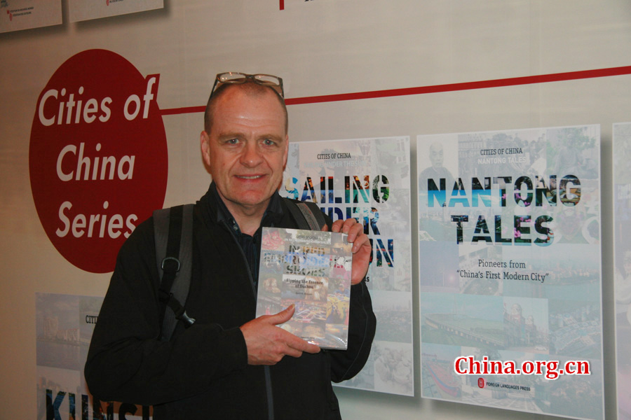 David W Ferguson, author of 'In Red Embroidered Shoes: Sipping the Essence of Suzhou', introduces his book at CIPG's booth. 