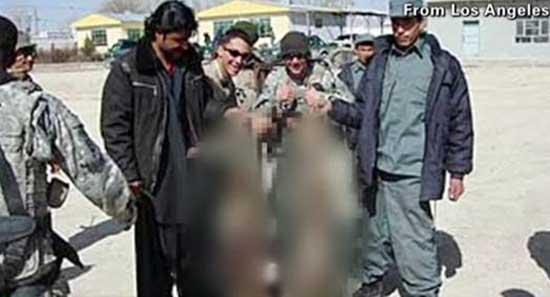 US troops pose with Afghan insurgent bodies. 