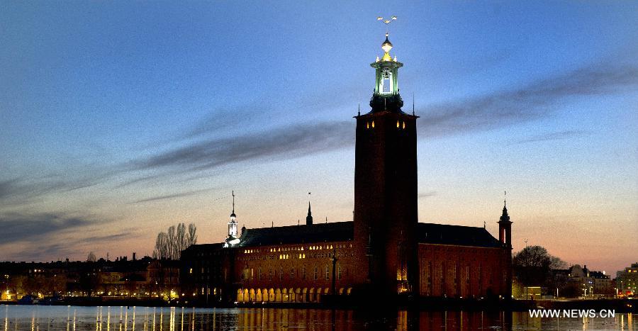 The City Hall of Stockholm is seen at dusk in Stockholm, Sweden, April 24, 2012. The sunset time comes later steadily as summer approaches. (Xinhua/Wang Ye) 