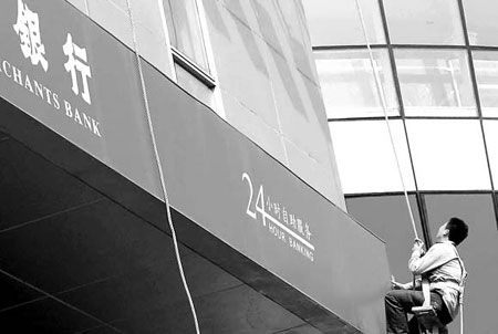 A worker cleans up the walls of a China Merchants Bank branch in Shanghai. Lenders' net income in China rose 39 percent last year to 1.25 trillion yuan ($178.4 billion). [China Daily]