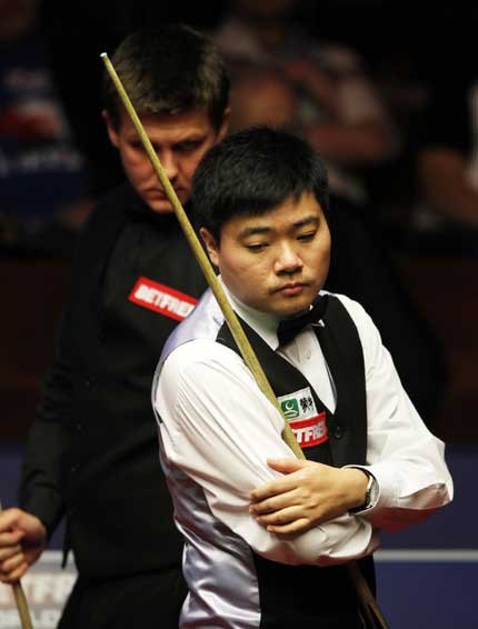 China's Ding Junhui in action against Ryan Day (back) of Wales during their first-round match at the world championships in Sheffield, England, yesterday. Ding lost 9-10.  