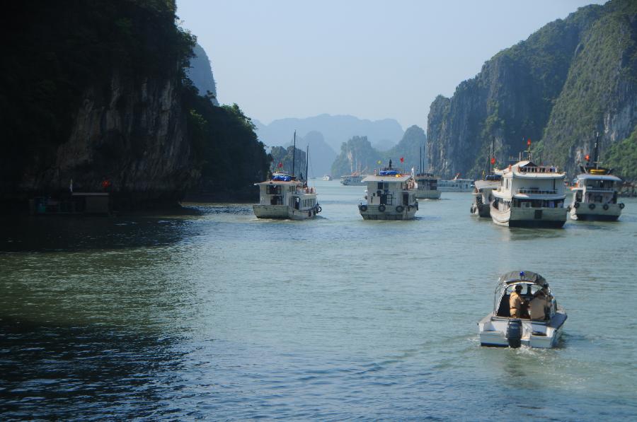 Ships cruise at Vinh Ha Long, a beautiful scenic spot of Vietnam, on May 1, 2012. Ha Long Vinh attracted 24,000 tourists home and abroad on April 29, according to local statistics. (Xinhua/Li Dan) 