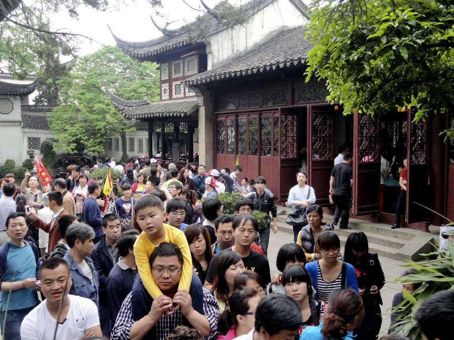 The Lingering Garden, one of the four most well-known gardens in China, is swarmed with tourists in Suzhou, east China's Jiangsu Province, April 30, 2012. As weather warms, a good many people choose to spend the three-day Labor Day holiday in travelling. (Xinhua/Wang Jiankang) 