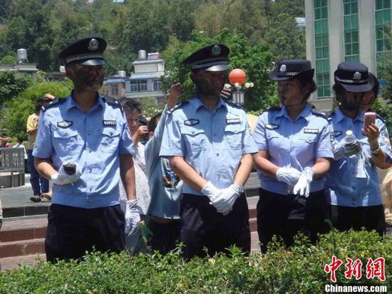 The police on duty were painted black by visitors. (CNS Photo/Jin Peipei)