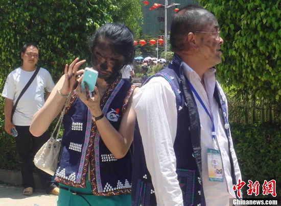 Visitors with painted face at Sun Plaza. (CNS Photo/Jin Peipei)