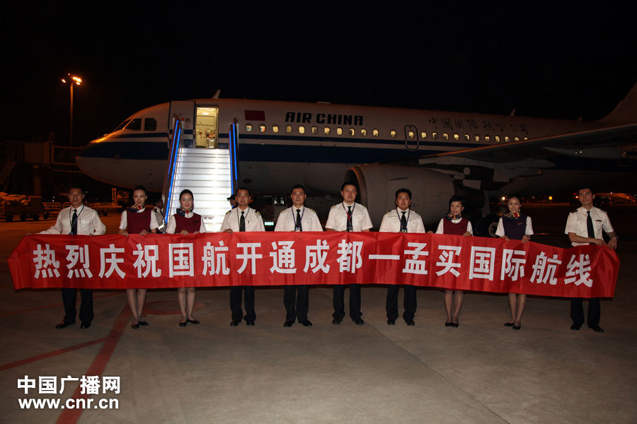 Air China crew members roll out a banner to celebrate the launch of the airline’s direct flight from Chengdu to Mumbai on May 2, 2012. [www.cnr.cn]