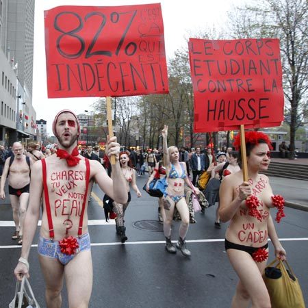 Students march against tuition hikes during a protest in downtown Montreal, Quebec, May 3, 2012. Placards read &apos;We are freezing our asses off for free school.&apos; (R) and &apos; 82% who are indecent.&apos; [Photo/Agencies]