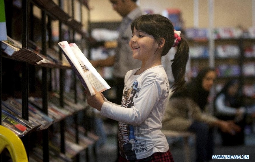 A girl browses books at the 25th Tehran International Book Fair in Tehran, Iran, May 6, 2012. More than 2,400 Iranian and 1,600 companies from 77 countries and regions attended the 11-day book fair. (Xinhua/Ahmad Halabisaz) 